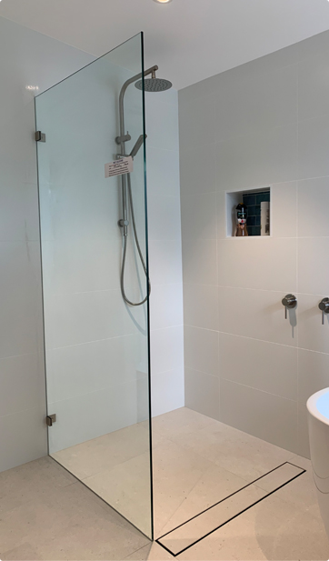 Frameless fixed panel shower screen installed in a modern Canterbury-Bankstown bathroom