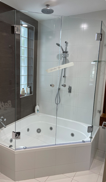 Frameless swing panel shower screen installed in a modern Canterbury-Bankstown bathroom, supplied and installed by Ezy Glide.